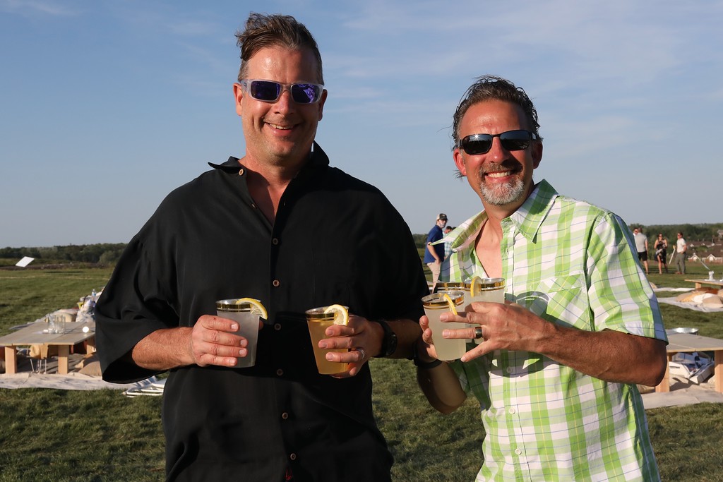 two guys holding drinks